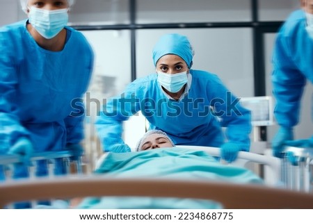 Surgeon, bed and rush in a hospital for emergency operation in the er with a sick patient. Surgery team, pushing sleeping woman and fast hospital bed in the theater for surgical medicine procedure