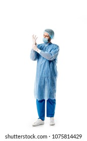 Surgeon in blue uniform wearing medical gloves isolated on white