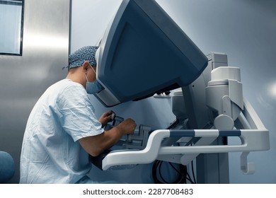 The surgeon is at the computer robot in a special control module, the medical robot is under the control of the doctor at a distance through the monipulator. Robotic surgery without incision - Powered by Shutterstock