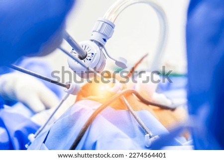 Surgeon or doctor did laparoscopy or endoscopy on minimal invasive surgery inside operating room in hospital.Surgeon in blue uniform did arthroscopic joint surgery with medical equipment or technology