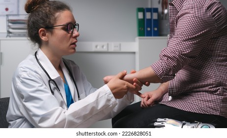 Surgeon examine amputated limb of male patient. Close up of therapist check amputated hand of young man in hospital