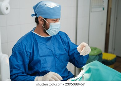 Surgeon in full surgical intervention performing a sterile operation. Concept: medicine, health care - Shutterstock ID 2395088469