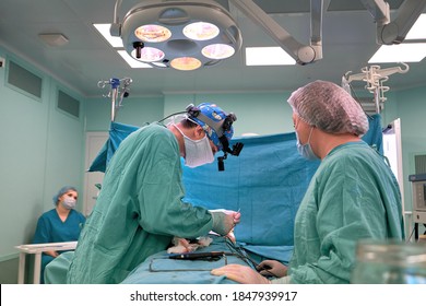 Surgeon and his assistant performing cosmetic surgery on nose in hospital operating room. Nose reshaping, augmentation. Rhinoplasty. - Shutterstock ID 1847939917