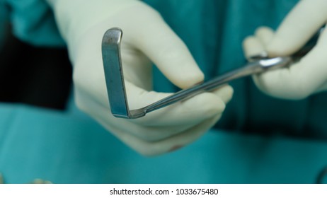 Surgeon Holding The Small Retractor , A Surgical Instrument For Minor Procedure.