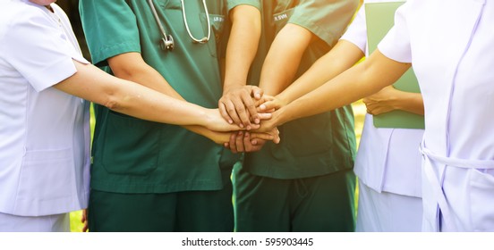 Surgeon medical people handshaking.Doctors and nurses in a medical team stacking hands.