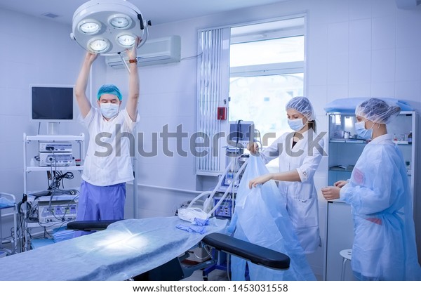 Surgeon Nurse Preparing Surgery Operating Room Stock Photo