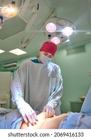 surgeon in the operating room performs an operation on a patient