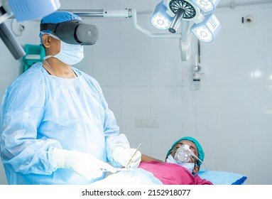 Surgeon Operating Surgery Using VR Goggles At Hospital Operation Theater Showing With Copy Space - Concept Of Modern Healtcare Technology, Vitual Reality And Futuristic