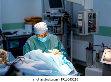 Surgeon in operation room. Working with surgical instruments. Modern equipment in operating room.