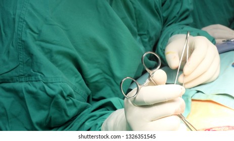 Surgeon Performing A Dissection To Raise Flap During Mastectomy Surgery.