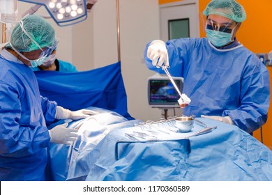 Surgeon performing operation in operating room - Shutterstock ID 1170360589