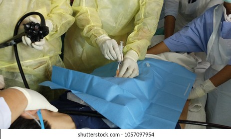 Surgeon Performing Percutaneous Endoscopic Gastrostomy With Abdominal Cannulation Under Local Anaesthetia