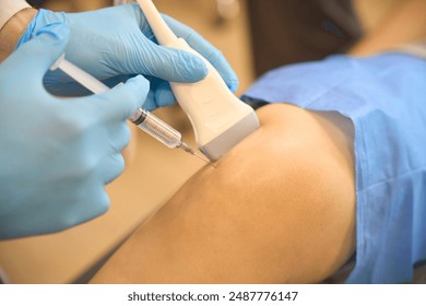 Surgeon performing ultrasound-guided lower extremity joint aspiration - Powered by Shutterstock