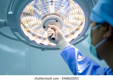 Surgeon or physician assistant Surgical lighting is being adjusted to light up when the medical team is working. - Powered by Shutterstock