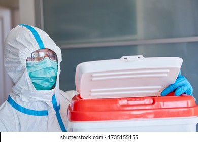 Surgeon In Protective Clothing In Clinic With Organ Donation After Transport In A Box Before Heart Transplant