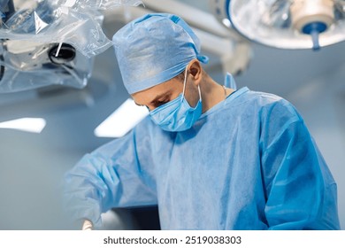 Surgeon in a sterile operating room. A medical professional focuses intently during a surgical procedure while wearing protective attire in an operating room setting. - Powered by Shutterstock