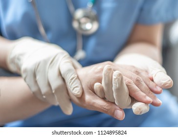 Surgeon, surgical doctor, anesthetist or anesthesiologist holding patient's hand for health care trust and support in professional surgical operation, medical anesthetic safety, ER healthcare concept