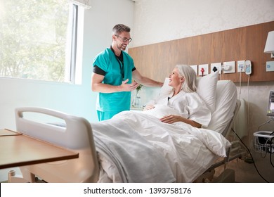 Surgeon Visiting And Talking With Mature Female Patient In Hospital Bed