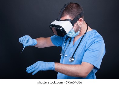 Surgeon wearing scrubs and face mask using virtual reality glasses and bistoury on black background