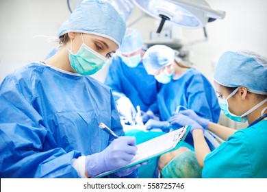 Surgeon Writing Down Some Operation Notes 