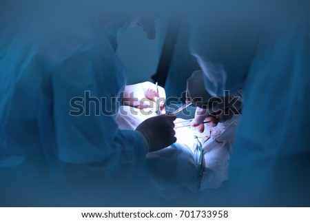 surgeons do surgery in a modern operating room or clinic