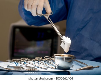 Surgeons Or Doctor Hands With Protective Glove Hold Sponge Holding A Sterilzed Gauze With Betadine Antiseptic Liquid For Skin To Clean Or Prep Wounds And Surgical Areas In Operation Room,Health Care,