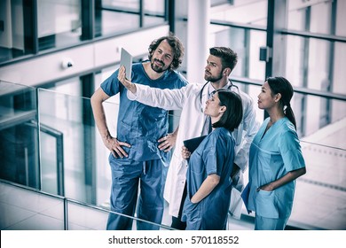 Surgeons, Doctor And Nurse Looking At Digital Tablet In Hospital