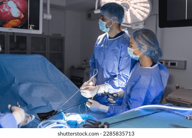 The surgeon's holing the instrument in abdomen of patient. The surgeon's doing laparoscopic surgery in the operating room. Minimally invasive surgery. - Powered by Shutterstock