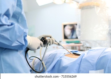 The surgeon's holing the instrument in abdomen of patient. The surgeon's doing laparoscopic surgery in the operating room. Minimally invasive surgery.