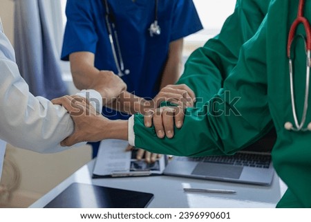 Surgeons join together after work to help patients in hospital operating room, emergency, surgery, medical technology Join together to cheer and celebrate post-surgery success and help patients.