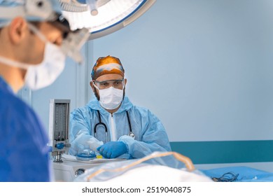 Surgeons operate in a sterile room. Surgical team in protective gear focuses on patient care while conducting a procedure in a modern, sterile operating room. - Powered by Shutterstock