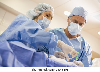 Surgeons Operating On Patient