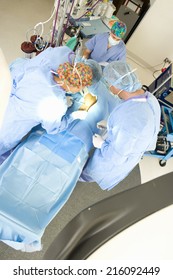 Surgeons operating on patient, elevated view