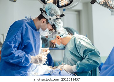 Surgeons perform a complex operation in a modern operating room. Two surgeons focus intently as they conduct a delicate procedure in a well-equipped surgical suite. - Powered by Shutterstock