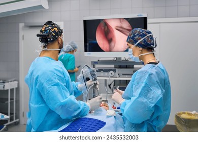 Surgeons perform complex surgery in the operating room