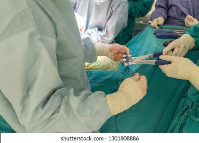 Surgeons Perform Spine Surgery In Modern Operating Room. Doctors Curving The Rod Instrument In Case Of Spinal Fusion.  Low Contrast And Shallow DOF. Medical Concept 