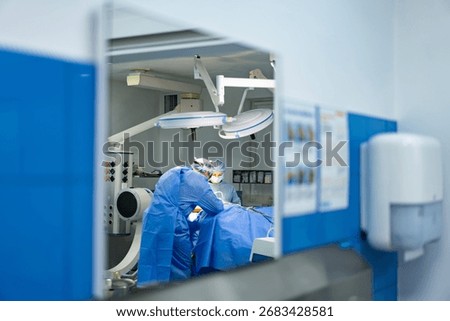 Surgeons performing delicate procedure in operating room. Medical team working together during surgical procedure in a modern hospital.