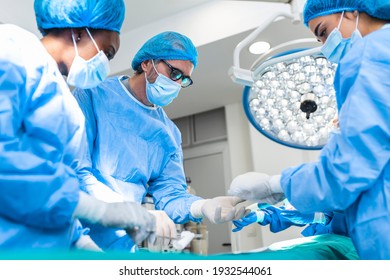 Surgeons performing operation in operation theater. breast augmentation surgery in the operating room surgeon tools implant. Medical care concept. - Shutterstock ID 1932544061