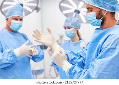 Surgeons put on disposable gloves as hygiene before surgery in the hospital - Powered by Shutterstock