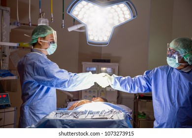 Surgeons shaking hands in operation room at hospital. Health care and Medical concept. - Powered by Shutterstock