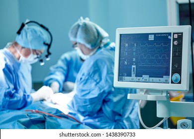A surgeon's team in uniform performs an operation on a patient at a cardiac surgery clinic. Modern medicine, a professional team of surgeons, health.