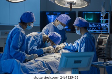 Surgeons team working with Monitoring of patient in surgical operating room. The doctors and nurses brainstorm power assisted surgery. A team of professional doctors perform surgery in a hospital - Powered by Shutterstock