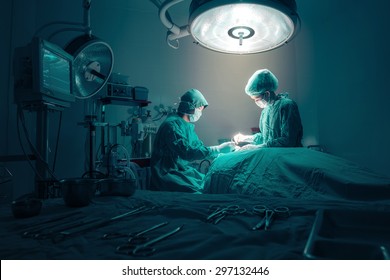 Surgeons team working with Monitoring of patient in surgical operating room.
