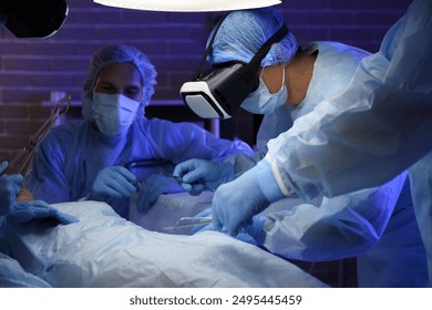 Surgeons with VR glasses operating patient in clinic - Powered by Shutterstock