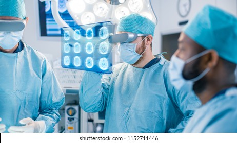 Surgeons Wearing Augmented Reality Glasses Perform State Of The Art Augmented Reality Surgery In High Tech Hospital. Surgeon Looks At Brain Scans And Medical History Of The Patient.