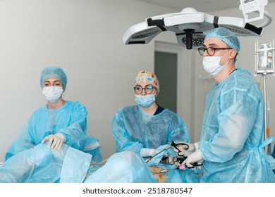 Surgeons at work in a hospital. A surgical team in protective gear collaborates during a procedure in a sterile operating room, ensuring patient safety. - Powered by Shutterstock