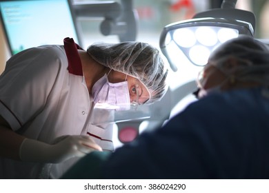 Surgeons working in operating theater - Powered by Shutterstock