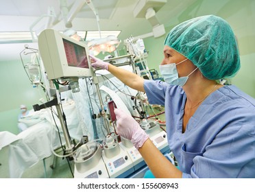 Surgery Assistant Nurse Working With Artificial Cardiac Valve At Operation In Cardiology Clinic