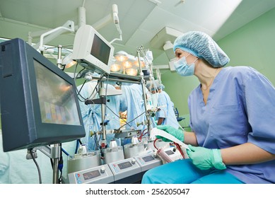 Surgery Assistant Nurse Working With Artificial Cardiac Valve At Operation In Cardiology Clinic