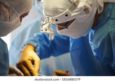 Surgery. Close-up Profile Portrait Of Surgeons Wearing Special Protective Clothing.